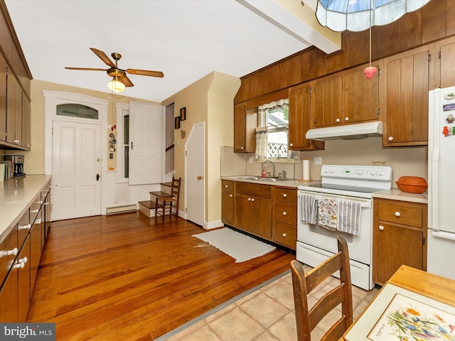 36 Fulton Ave, Walkersville, MD 21793 - kitchen featuring baseboard heating, white appliances, light countertops, and under cabinet range hood