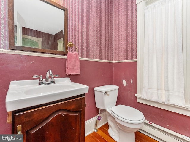 36 Fulton Ave, Walkersville, MD 21793 - bathroom featuring a baseboard heating unit, vanity, toilet, and wood finished floors