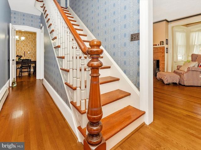 36 Fulton Ave, Walkersville, MD 21793 - staircase with a fireplace, baseboards, wallpapered walls, and wood finished floors