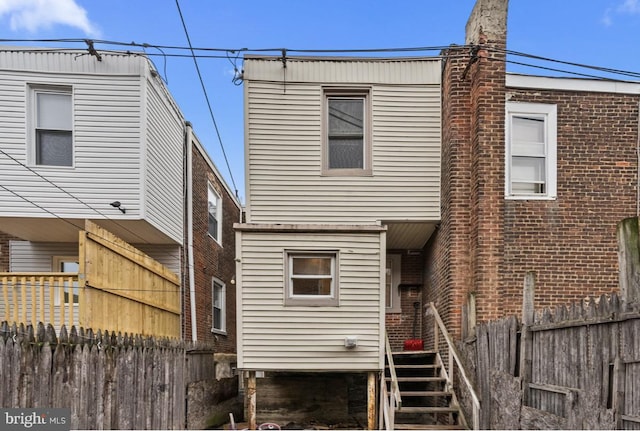 rear view of house with fence