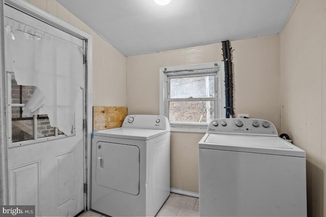 laundry area with laundry area, light tile patterned floors, and washer and clothes dryer