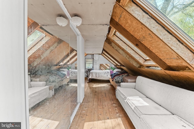 interior space featuring vaulted ceiling and wood-type flooring