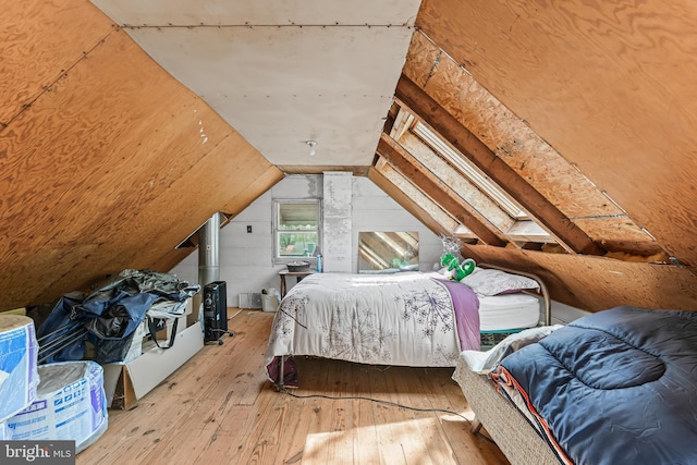 bedroom with hardwood / wood-style floors and vaulted ceiling