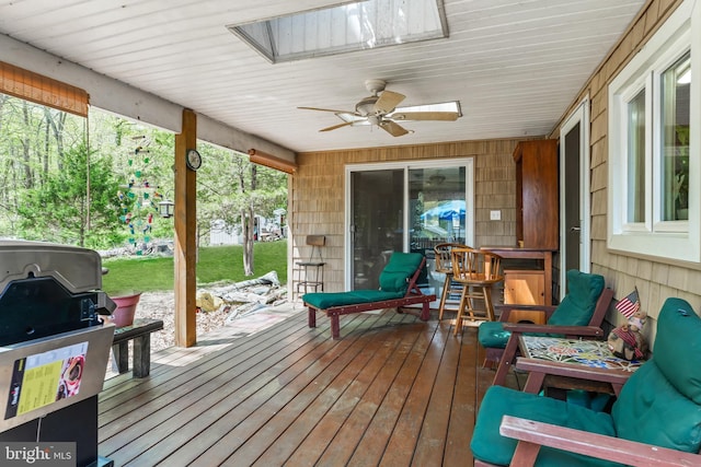 deck featuring ceiling fan and area for grilling