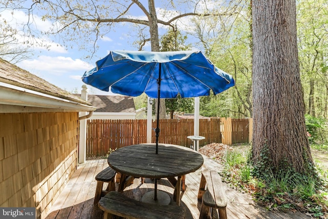 view of patio with fence and a deck