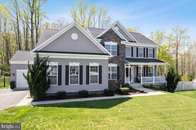 1230 Fairwood Dr, Huntingtown, MD 20639 - view of front facade featuring covered porch, fence, aphalt driveway, an attached garage, and a front lawn