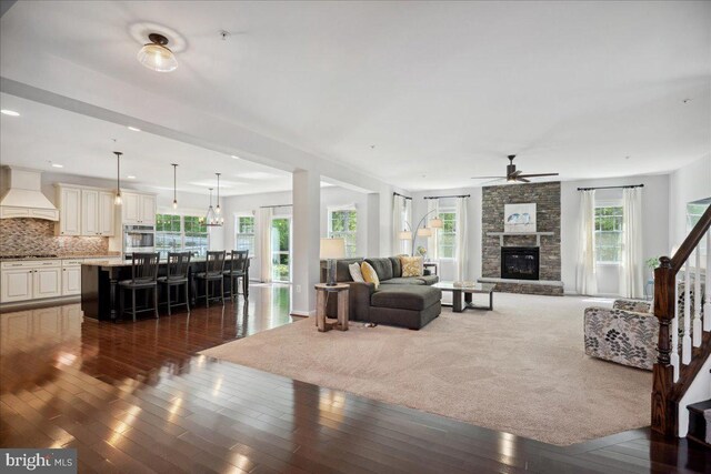 1230 Fairwood Dr, Huntingtown, MD 20639 - living area with a stone fireplace, recessed lighting, dark wood finished floors, and ceiling fan