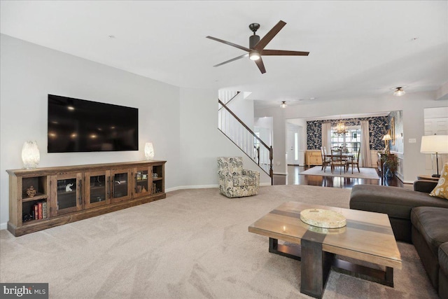 1230 Fairwood Dr, Huntingtown, MD 20639 - carpeted living room featuring baseboards, stairway, and ceiling fan with notable chandelier
