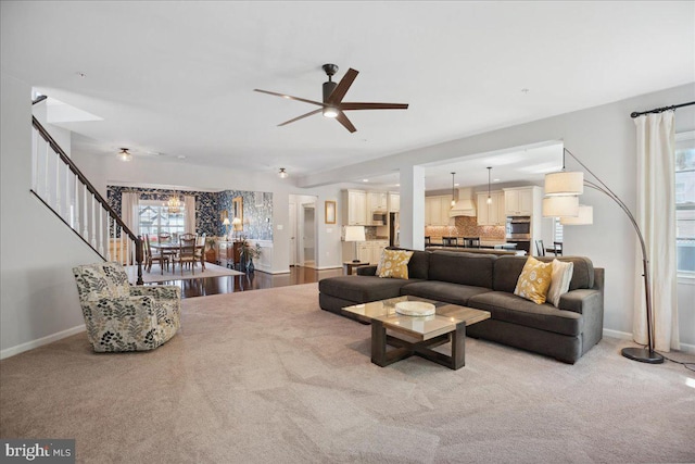 1230 Fairwood Dr, Huntingtown, MD 20639 - living room with baseboards, a ceiling fan, stairs, and light colored carpet