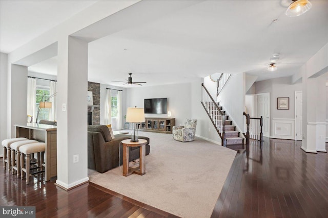 1230 Fairwood Dr, Huntingtown, MD 20639 - living area featuring wood-type flooring, a fireplace, baseboards, ceiling fan, and stairway