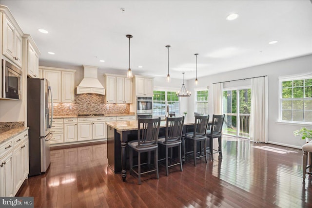 1230 Fairwood Dr, Huntingtown, MD 20639 - kitchen featuring stainless steel appliances, light stone countertops, custom exhaust hood, and dark wood-style flooring