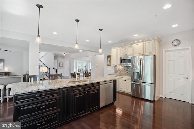 1230 Fairwood Dr, Huntingtown, MD 20639 - kitchen with dark wood-style floors, cream cabinetry, dark cabinetry, a sink, and appliances with stainless steel finishes