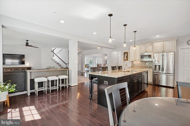 1230 Fairwood Dr, Huntingtown, MD 20639 - kitchen with open floor plan, dark wood-type flooring, cream cabinets, a sink, and stainless steel appliances