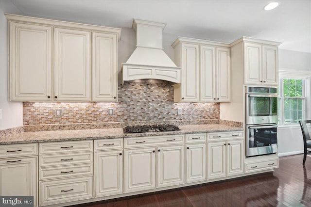 1230 Fairwood Dr, Huntingtown, MD 20639 - kitchen featuring appliances with stainless steel finishes, cream cabinetry, custom range hood, and tasteful backsplash