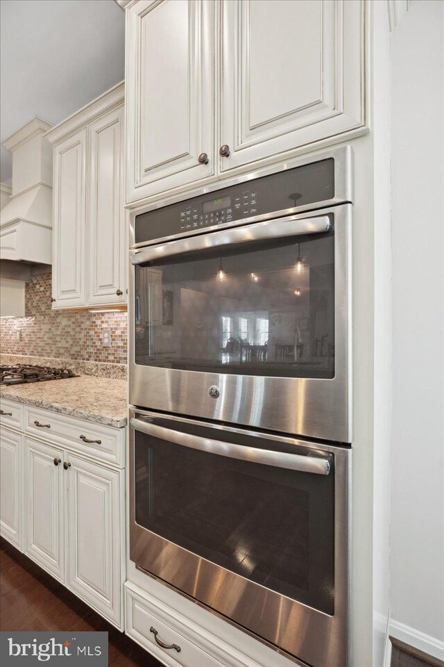 1230 Fairwood Dr, Huntingtown, MD 20639 - interior details featuring tasteful backsplash, light stone countertops, stainless steel appliances, and white cabinets