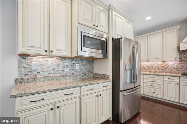 1230 Fairwood Dr, Huntingtown, MD 20639 - kitchen with decorative backsplash, light stone countertops, stainless steel appliances, and dark wood-style flooring