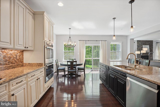 1230 Fairwood Dr, Huntingtown, MD 20639 - kitchen featuring decorative backsplash, dark wood-style flooring, appliances with stainless steel finishes, cream cabinets, and a sink