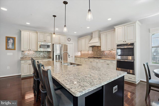 1230 Fairwood Dr, Huntingtown, MD 20639 - kitchen featuring premium range hood, dark wood-type flooring, light stone counters, a sink, and stainless steel appliances
