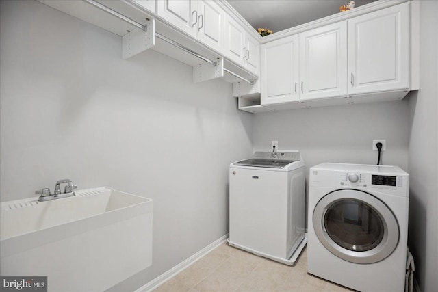 1230 Fairwood Dr, Huntingtown, MD 20639 - washroom with baseboards, a sink, cabinet space, independent washer and dryer, and light tile patterned floors