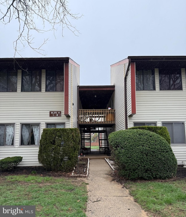 view of property with stairway and driveway