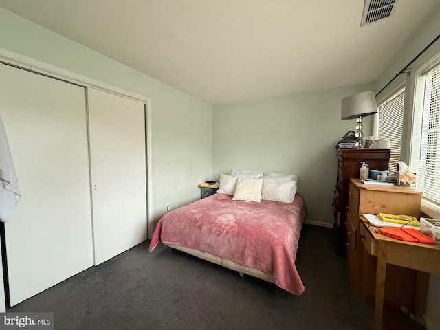 bedroom featuring a closet, carpet flooring, and visible vents
