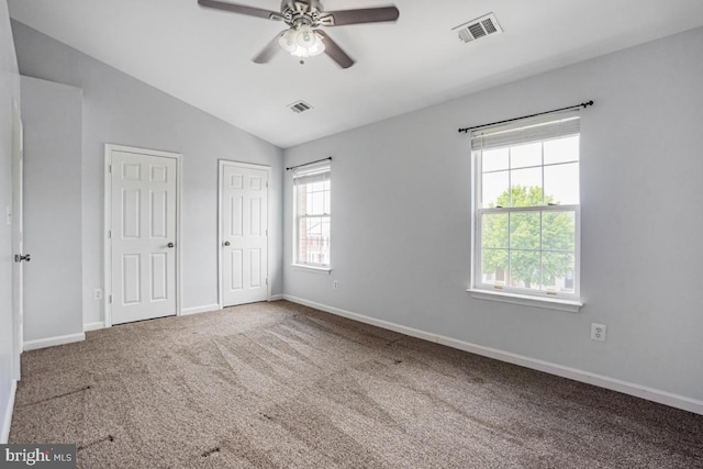9403 Robin Lee Ct, Manassas Park, VA 20111 - unfurnished bedroom with multiple closets, carpet floors, baseboards, vaulted ceiling, and a ceiling fan