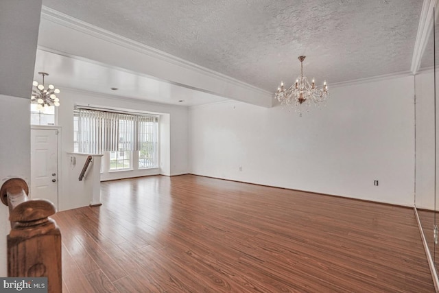 9403 Robin Lee Ct, Manassas Park, VA 20111 - unfurnished living room featuring a chandelier, a textured ceiling, wood finished floors, and ornamental molding