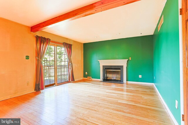 327 E Branch Rd, Sellersville, PA 18960 - unfurnished living room with beamed ceiling, light wood-style flooring, baseboards, and a fireplace with flush hearth