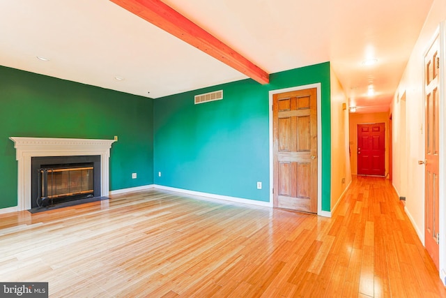 327 E Branch Rd, Sellersville, PA 18960 - unfurnished living room with visible vents, baseboards, light wood-style floors, beam ceiling, and a fireplace with flush hearth