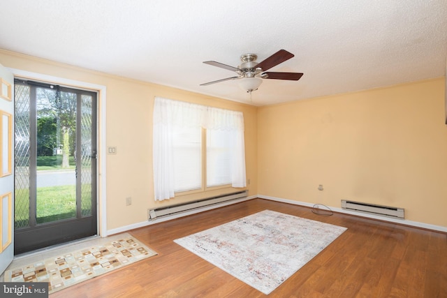 entrance foyer featuring baseboards, ceiling fan, wood finished floors, and baseboard heating