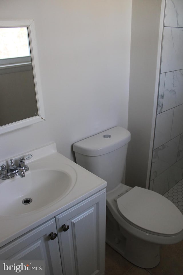 17 Rozina Ct, Owings Mills, MD 21117 - bathroom featuring toilet, tiled shower, and vanity