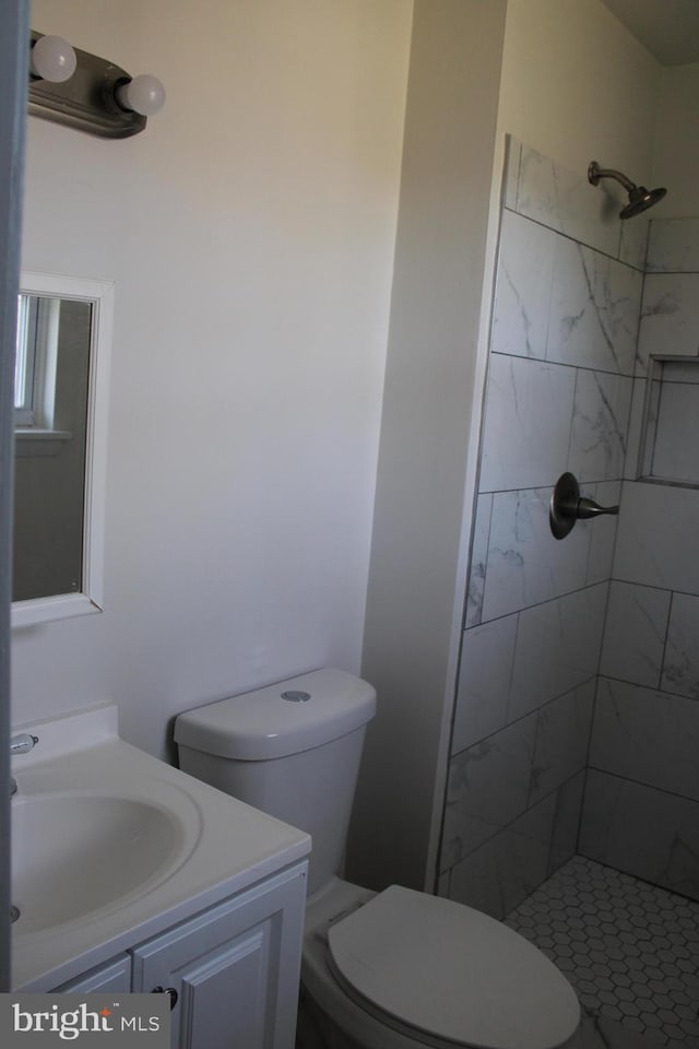 17 Rozina Ct, Owings Mills, MD 21117 - bathroom with a tile shower, toilet, and vanity