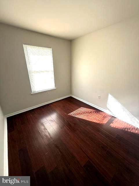 17 Rozina Ct, Owings Mills, MD 21117 - unfurnished room with wood-type flooring, visible vents, and baseboards