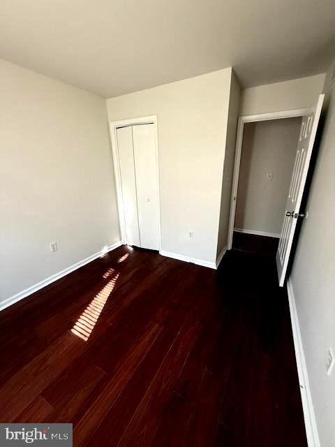 17 Rozina Ct, Owings Mills, MD 21117 - unfurnished bedroom featuring wood finished floors, baseboards, and a closet