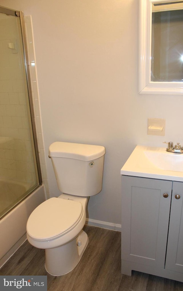 17 Rozina Ct, Owings Mills, MD 21117 - bathroom with shower / bath combination with glass door, vanity, toilet, wood finished floors, and baseboards