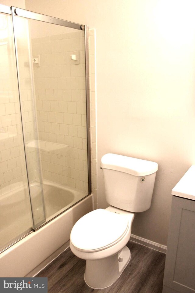 17 Rozina Ct, Owings Mills, MD 21117 - bathroom with shower / bath combination with glass door, vanity, baseboards, toilet, and wood finished floors