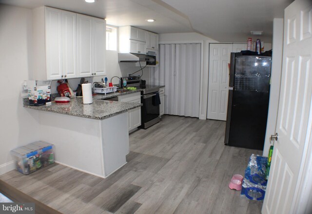 17 Rozina Ct, Owings Mills, MD 21117 - kitchen with light stone counters, stainless steel electric range, light wood-style flooring, freestanding refrigerator, and white cabinets