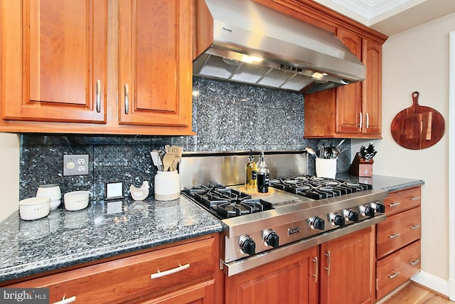 6704 Emporia Ct, Springfield, VA 22152 - kitchen with exhaust hood, stainless steel gas cooktop, backsplash, and brown cabinetry