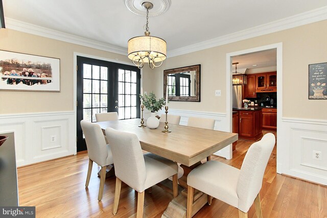6704 Emporia Ct, Springfield, VA 22152 - dining room with a chandelier, ornamental molding, light wood finished floors, a wainscoted wall, and a decorative wall