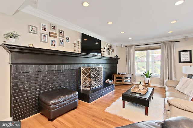 6704 Emporia Ct, Springfield, VA 22152 - living room featuring a brick fireplace, wood finished floors, recessed lighting, crown molding, and baseboards