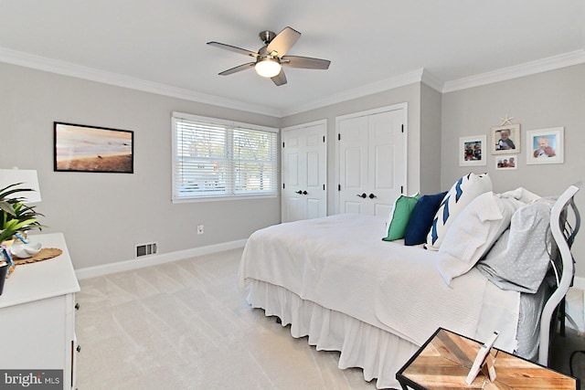 6704 Emporia Ct, Springfield, VA 22152 - bedroom with two closets, ornamental molding, baseboards, light colored carpet, and ceiling fan