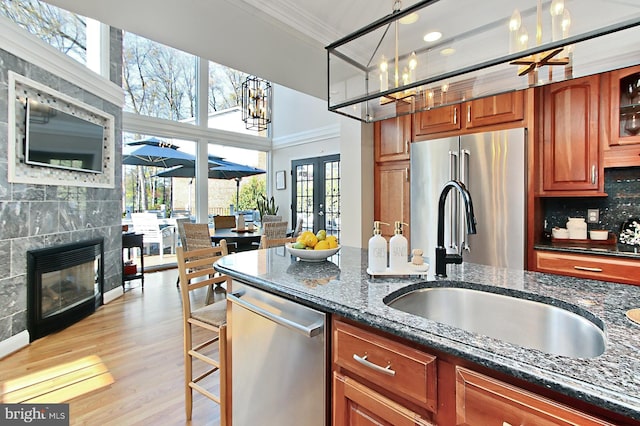 6704 Emporia Ct, Springfield, VA 22152 - kitchen featuring ornamental molding, a sink, stainless steel appliances, french doors, and dark stone counters