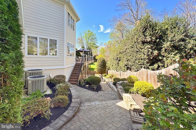 6704 Emporia Ct, Springfield, VA 22152 - view of patio featuring fence, stairway, central AC unit, and a deck