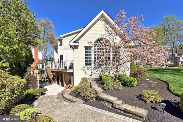 6704 Emporia Ct, Springfield, VA 22152 - view of front facade with stairs, brick siding, a wooden deck, and a front lawn