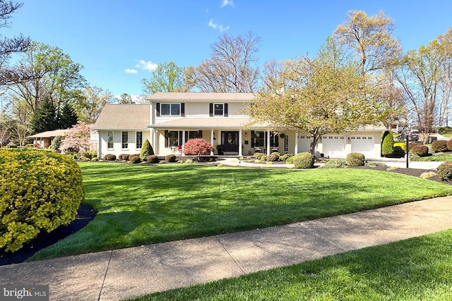 6704 Emporia Ct, Springfield, VA 22152 - traditional-style home featuring covered porch, a front lawn, a garage, and concrete driveway