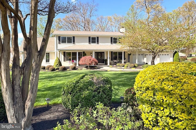 6704 Emporia Ct, Springfield, VA 22152 - traditional-style home with a front yard, a chimney, a porch, and an attached garage