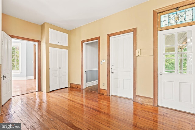 foyer entrance featuring baseboards and light wood finished floors