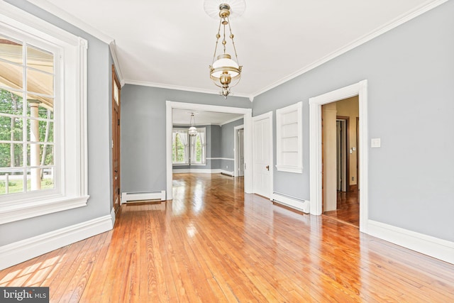 unfurnished dining area with crown molding, baseboards, a baseboard heating unit, and a notable chandelier