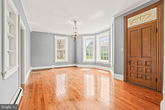 entryway featuring crown molding, light wood-type flooring, and a baseboard radiator