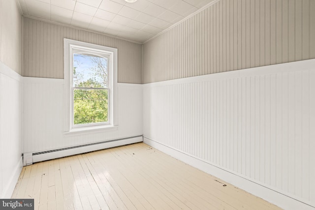 interior space with hardwood / wood-style floors and a baseboard heating unit